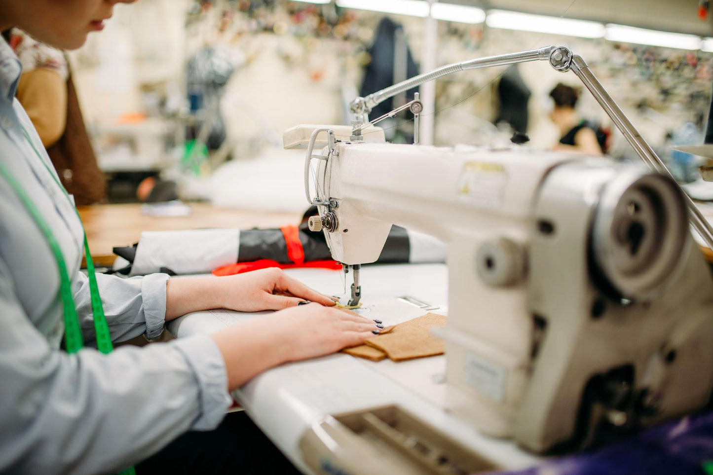 Student using a sewing machine in a professional NYC sewing class studio.