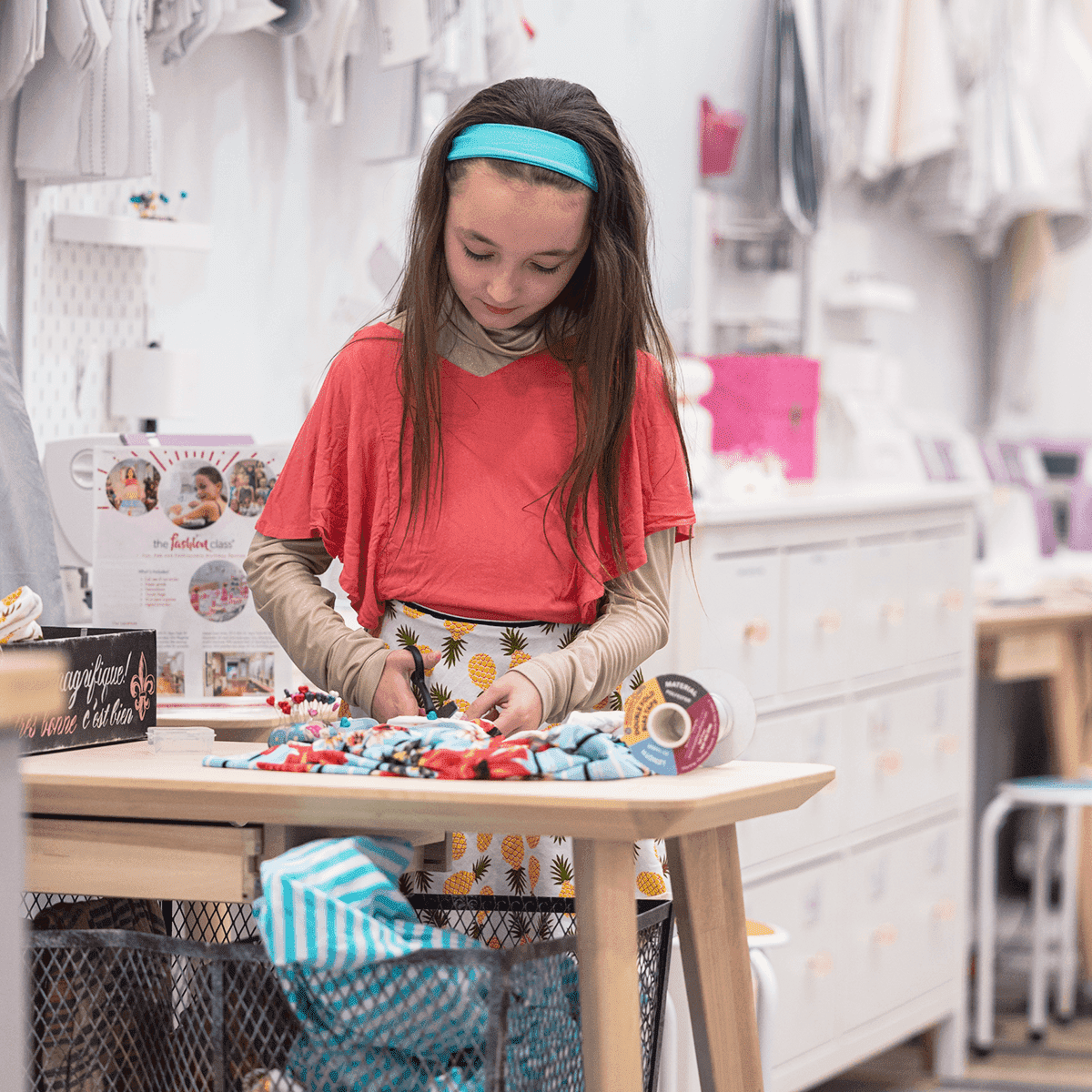 Girl cutting fabric to sew a custom dress