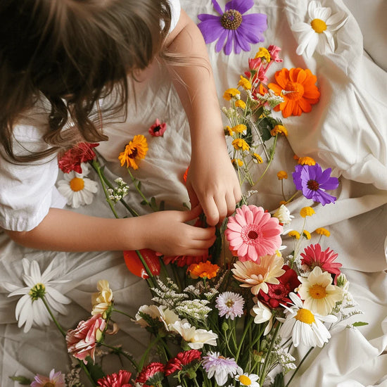 Little girl learning to make a flower bouquet