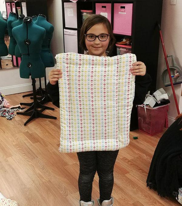 Little girl showing a pet blanket